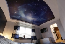 Bedroom with printed ceiling