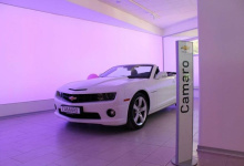 Car dealership with backlit wall